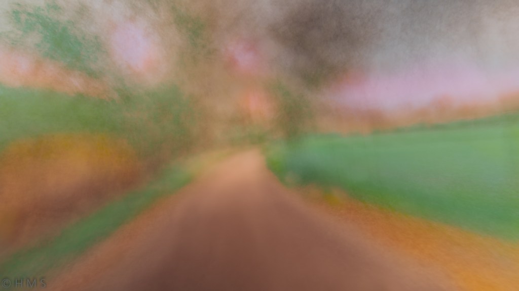 Green Meadow Path, abstract fine art photography with intentional camera movement (ICM); a luminous trail crossing a vibrant green meadow, dissolving into motion