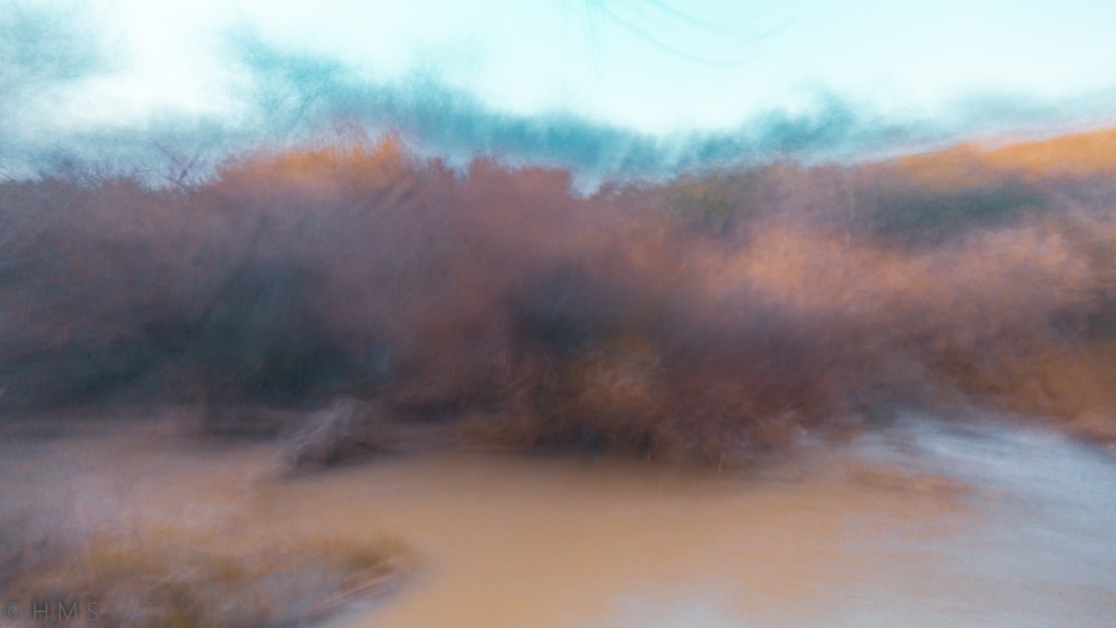 Impressionist river photograph with flowing water, shrubs, and sky blending into painterly harmony by Héctor Morón