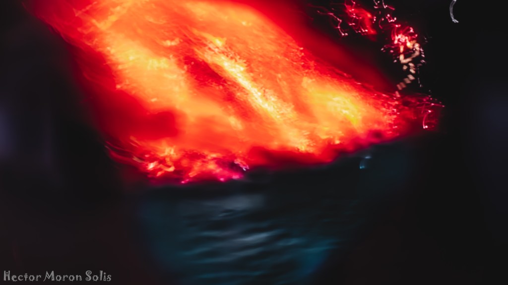 Lava Reaches the Sea II (Night), abstract volcanic fine art photography with intentional camera movement (ICM); glowing lava entering the dark ocean under night sky
