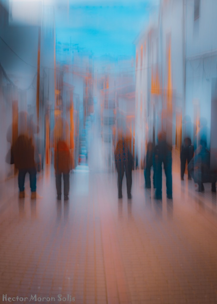 Abstract urban photograph with ghostly human figures aligned by city structures, moving upward toward the sky. Allegorical Abstractionism by Héctor Morón