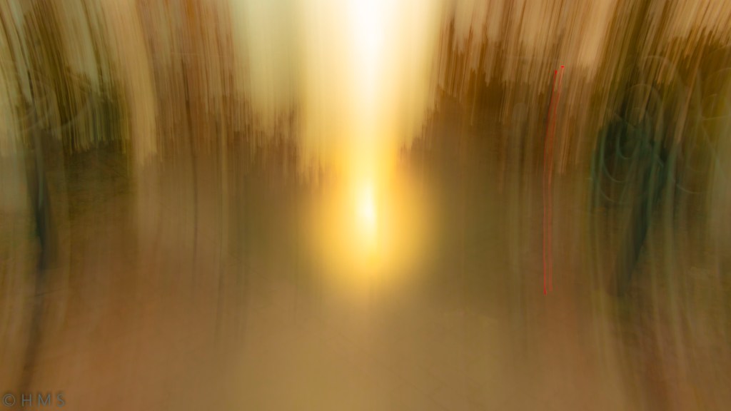 Abstract ICM photograph of a glowing sphere of light within a park, blending golden and green tones — fine art long exposure by Héctor Morón.