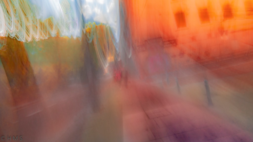 Abstract photograph of trees and city buildings blending into light and color — symbolic urban canopy by Héctor Morón Solís.